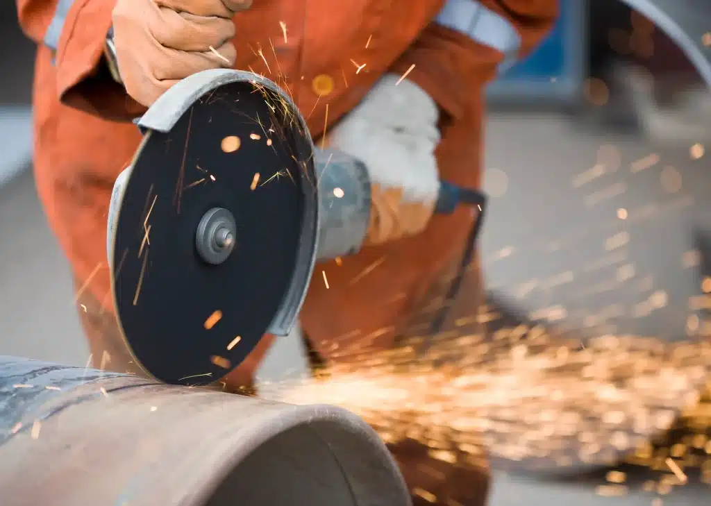 Operative using an abrasive wheel