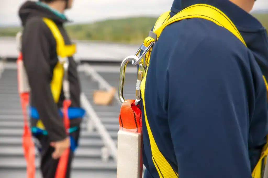 A worker wearing a harness & lanyard