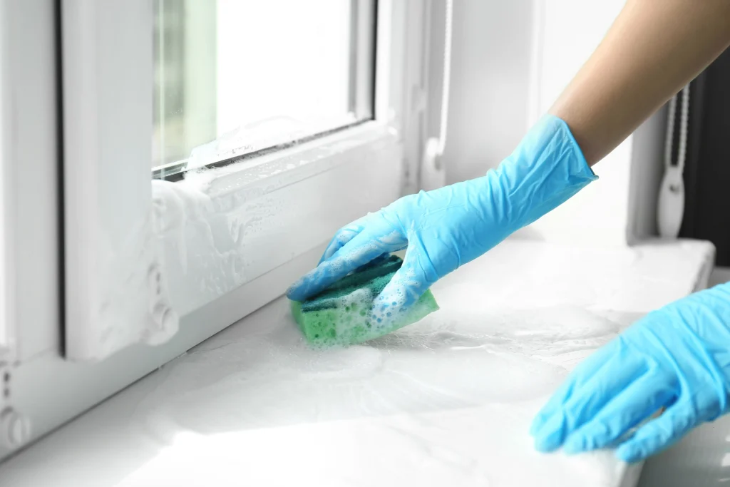 Operative using sponge to clean mould